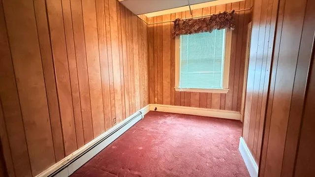 an empty room with windows and closet