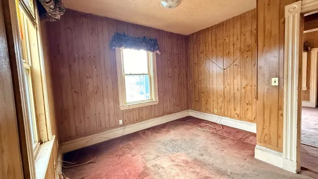 a view of a room with wooden walls