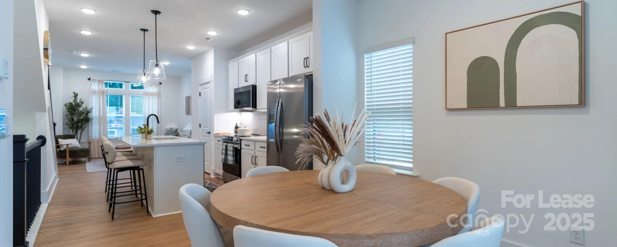 2619 Rozzelles Ferry Road Charlotte, NC 28208 - Photo 8 of 25 a dining room with wooden floor furniture and kitchen view