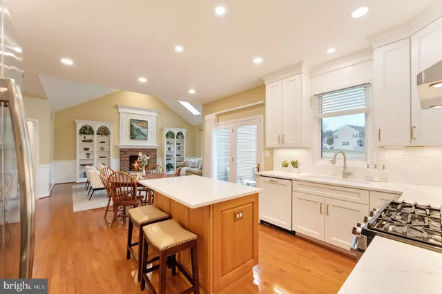 a living room with fireplace furniture and a large window