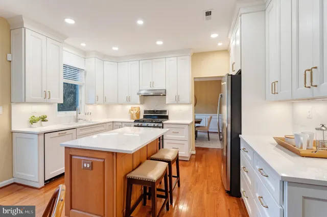 a bathroom with a granite countertop sink mirror and shower
