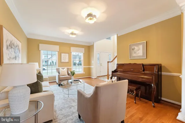 a view of a dining room with furniture a chandelier and wooden floor