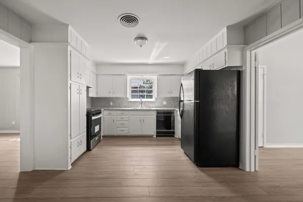 a kitchen with stainless steel appliances a refrigerator and a sink