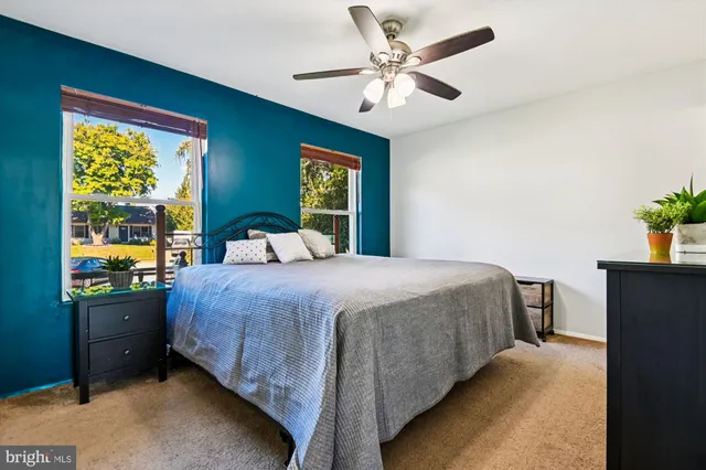 a bedroom with a bed dresser and a window