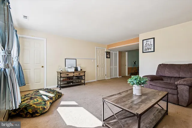 a bedroom with furniture and a potted plant