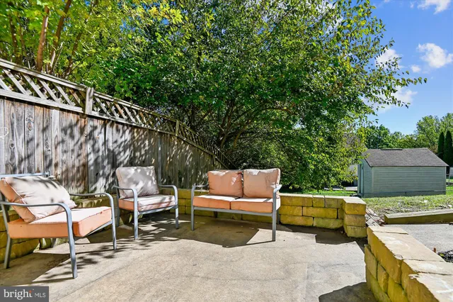 a backyard of a house with table and chairs