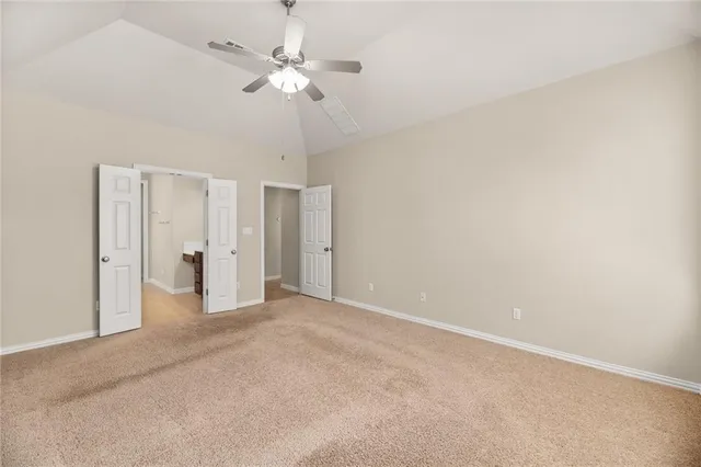 a view of an empty room with a ceiling fan