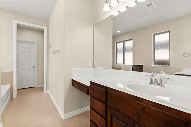 a bathroom with a sink a vanity and a mirror