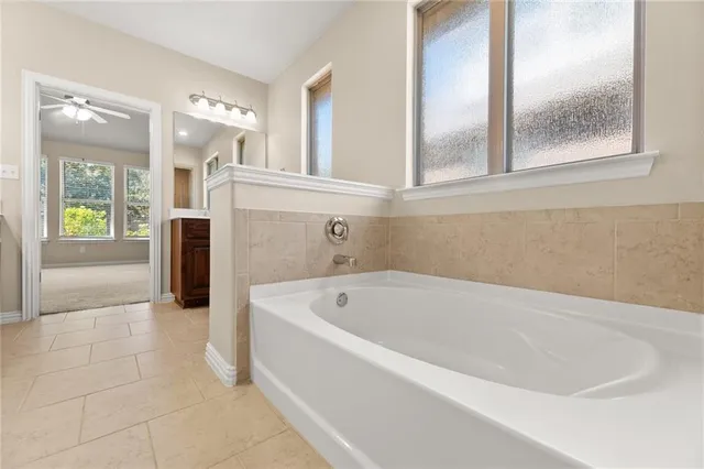 a bathroom with a bathtub and a shower