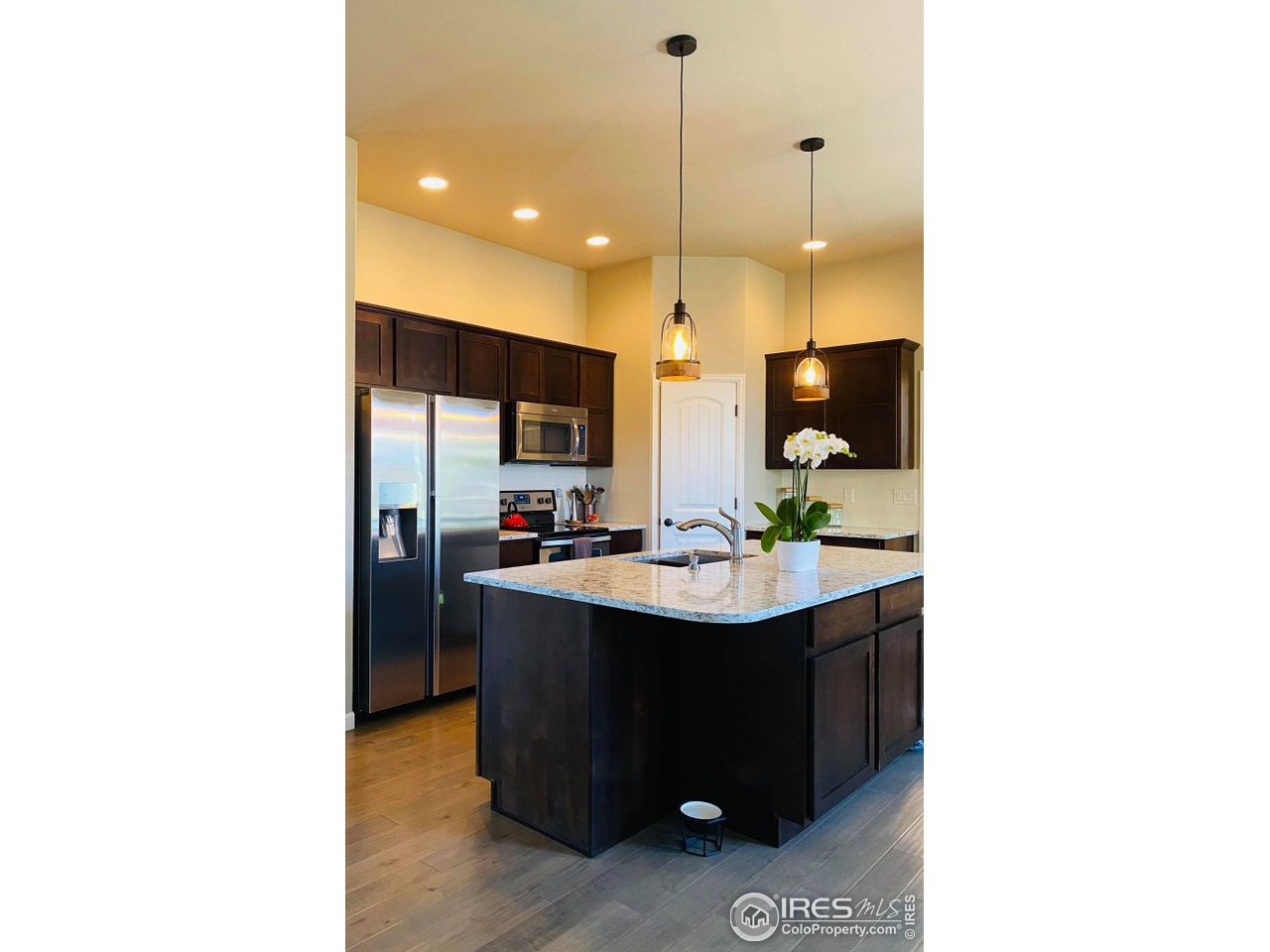 505 Deville Drive Greeley, CO 80634 - Photo 11 of 39 a kitchen with a sink a counter top space and stainless steel appliances