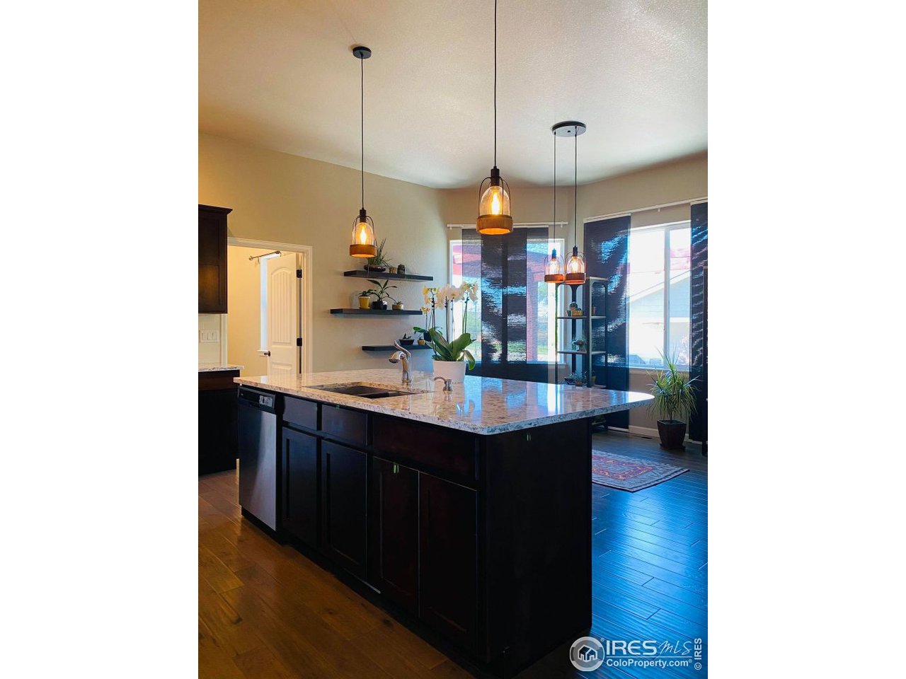 505 Deville Drive Greeley, CO 80634 - Photo 13 of 39 a kitchen with a sink and a refrigerator