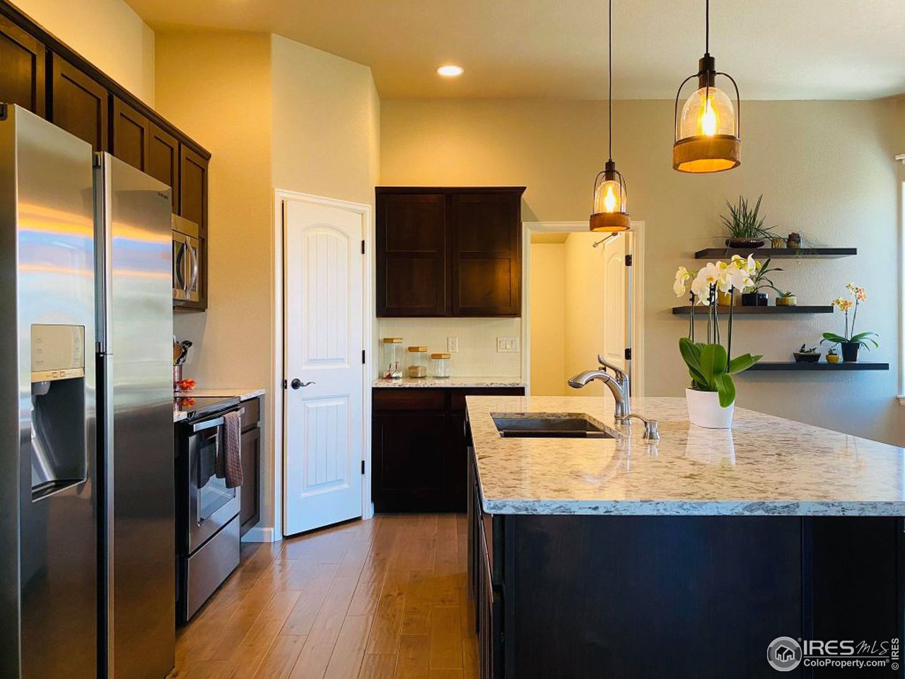 505 Deville Drive Greeley, CO 80634 - Photo 14 of 39 a kitchen with stainless steel appliances granite countertop a sink and a refrigerator