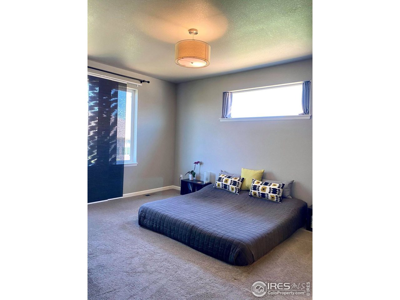 505 Deville Drive Greeley, CO 80634 - Photo 20 of 39 a living room with furniture and a chandelier
