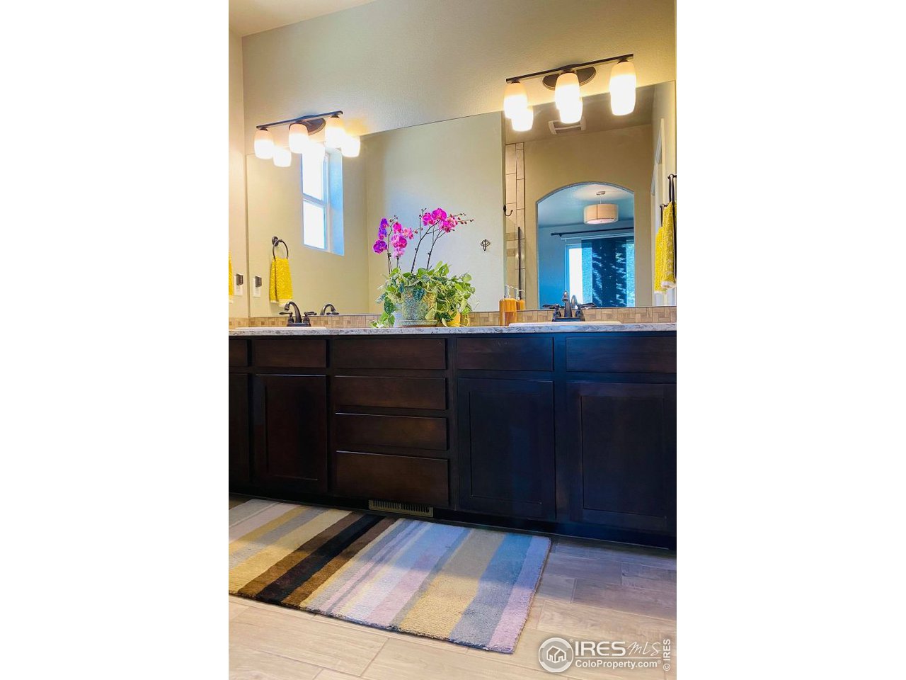 505 Deville Drive Greeley, CO 80634 - Photo 24 of 39 a living room with wooden floor and cabinet