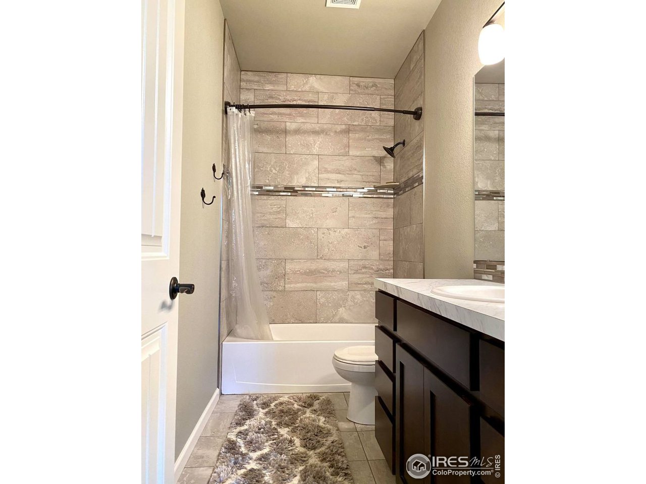 505 Deville Drive Greeley, CO 80634 - Photo 29 of 39 a bathroom with a bathtub and shower