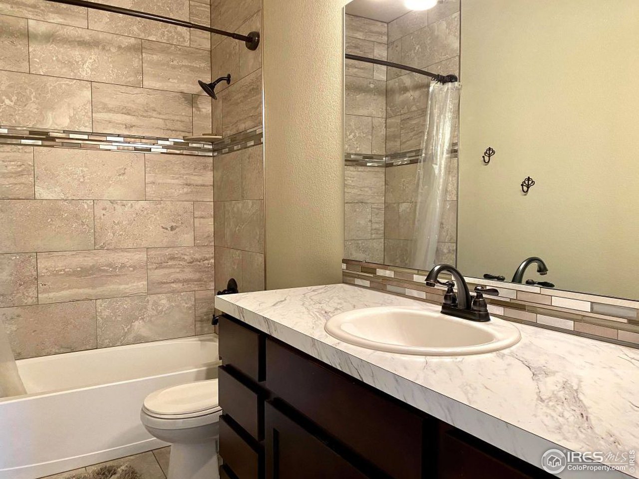 505 Deville Drive Greeley, CO 80634 - Photo 30 of 39 a bathroom with a sink a toilet and shower