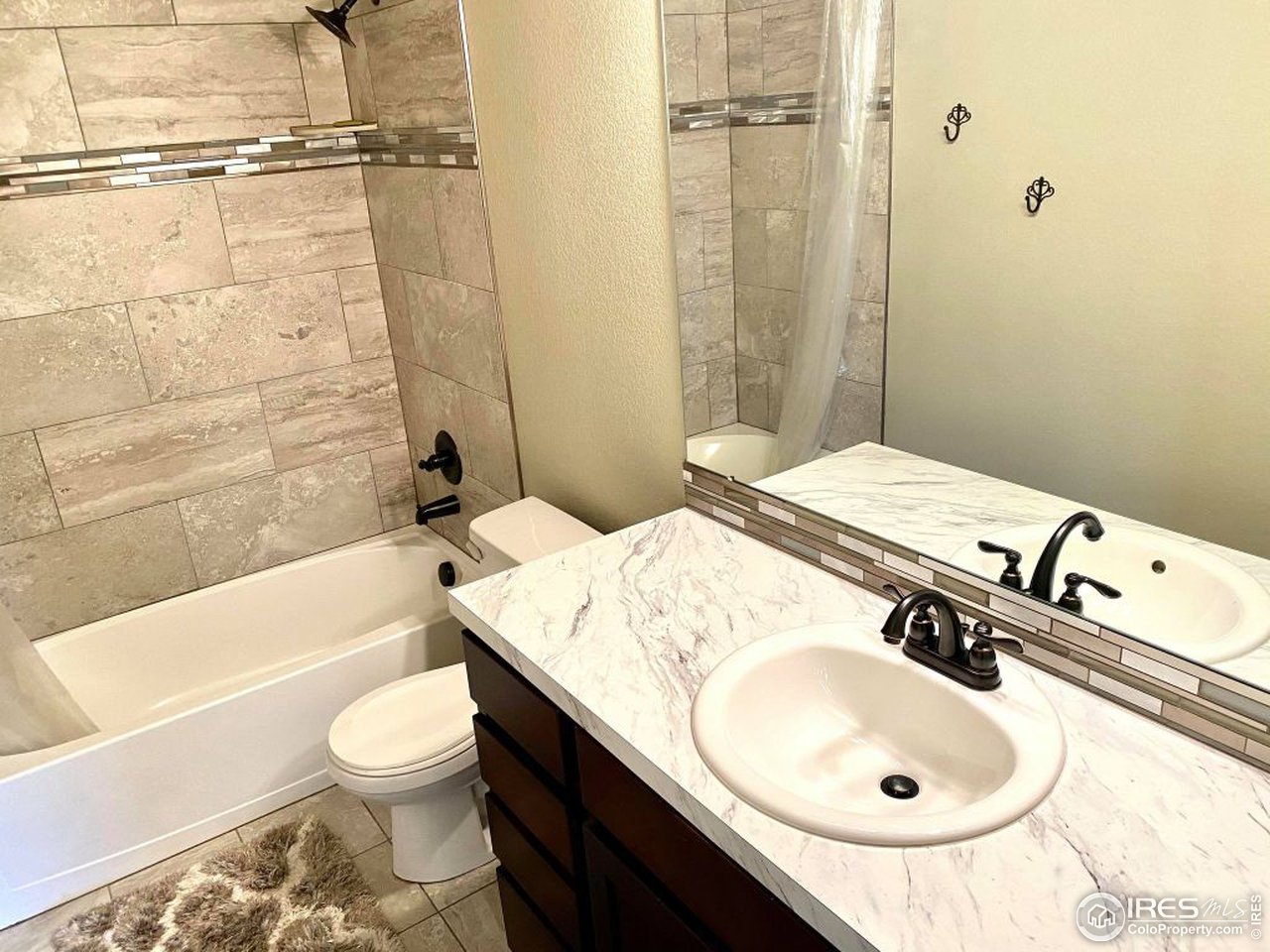 505 Deville Drive Greeley, CO 80634 - Photo 31 of 39 a bathroom with a sink toilet and shower