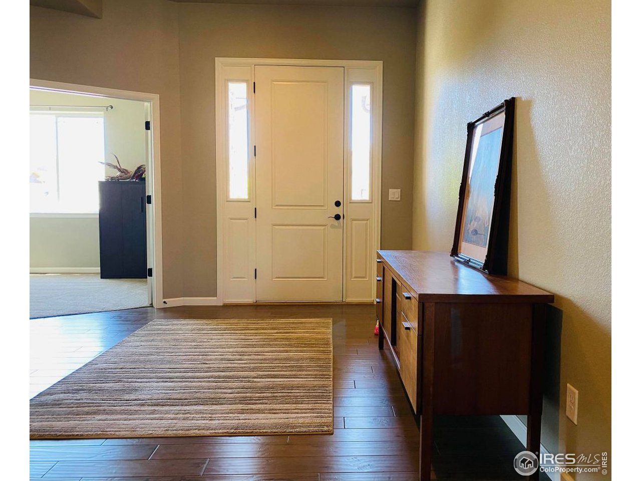 505 Deville Drive Greeley, CO 80634 - Photo 5 of 39 a view of a hallway with wooden floor and staircase