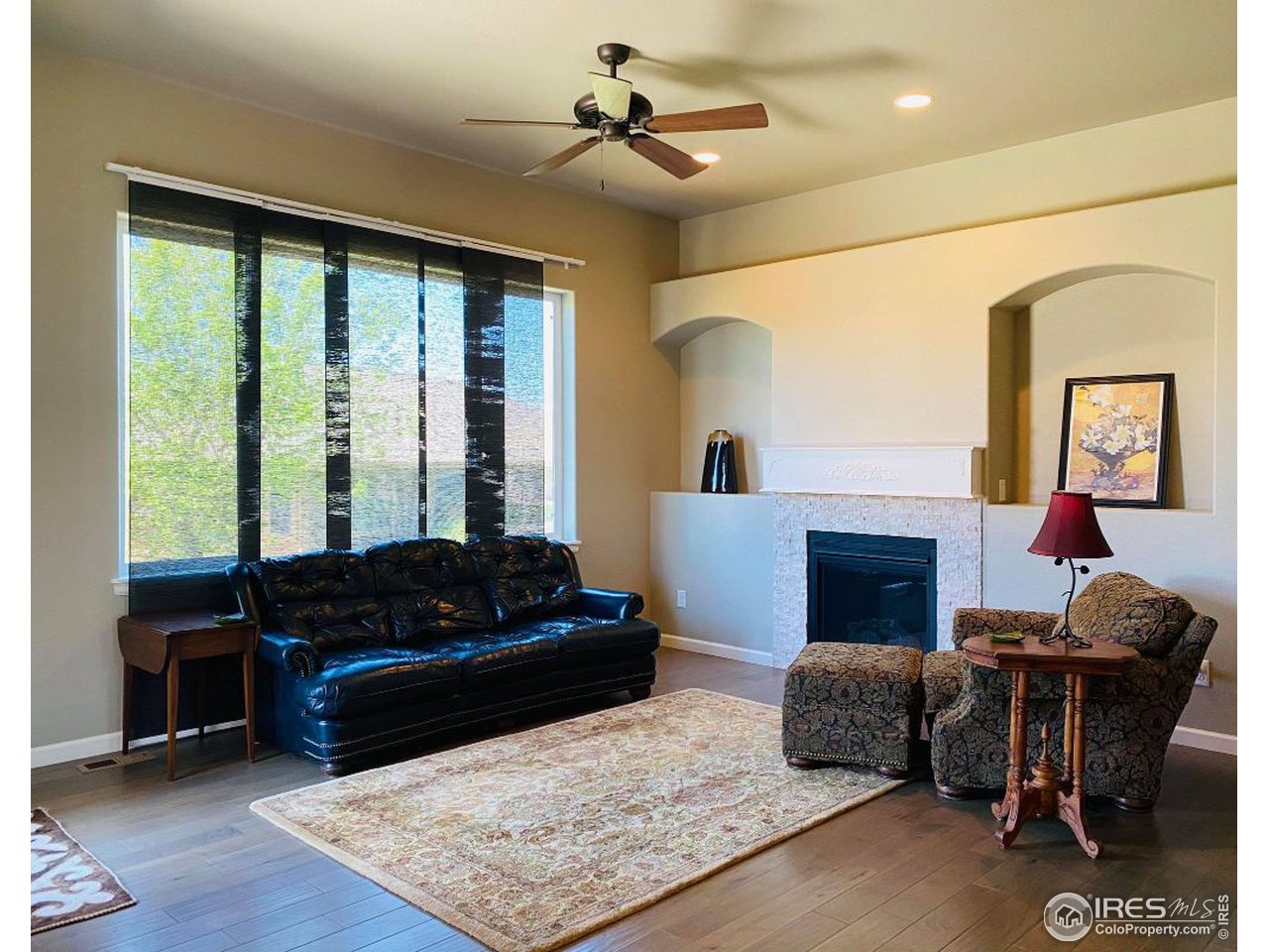505 Deville Drive Greeley, CO 80634 - Photo 7 of 39 a living room with furniture and a fireplace