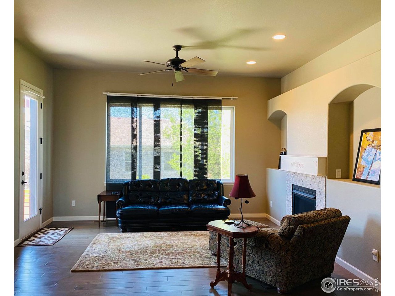 505 Deville Drive Greeley, CO 80634 - Photo 8 of 39 a living room with furniture and a fireplace