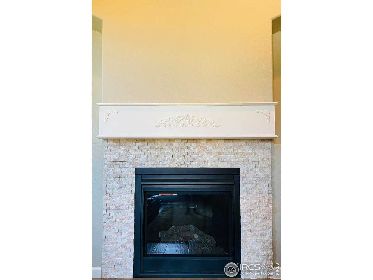 505 Deville Drive Greeley, CO 80634 - Photo 10 of 39 a close view of a fireplace in a room