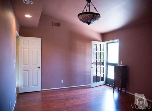 823 Warren Court Moorpark, CA 93021 - Photo 11 of 20 a view of an empty room with wooden floor and a window