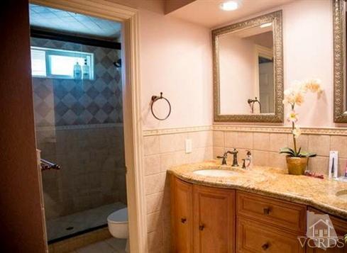 823 Warren Court Moorpark, CA 93021 - Photo 16 of 20 a bathroom with a shower sink and mirror