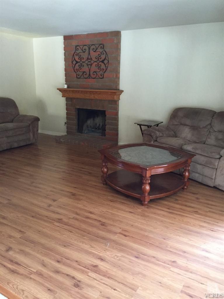 823 Warren Court Moorpark, CA 93021 - Photo 8 of 20 a living room with furniture and a fireplace