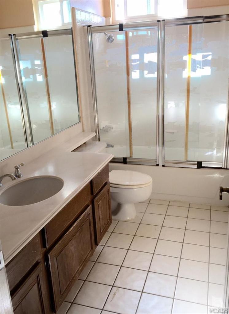 823 Warren Court Moorpark, CA 93021 - Photo 10 of 20 a bathroom with a sink a toilet and a mirror