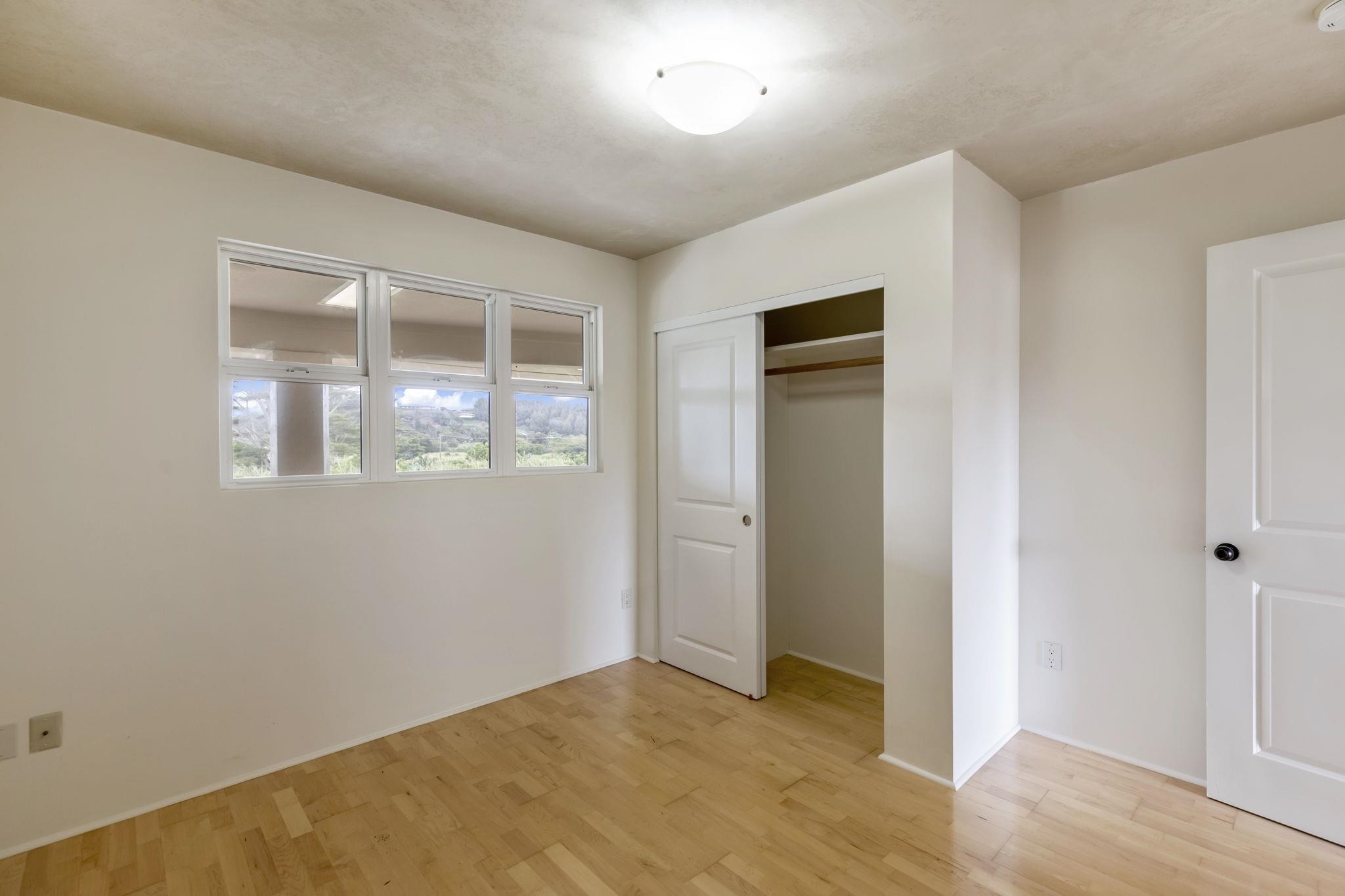 44 Pokoa Place Haiku, HI 96708 - Photo 17 of 29 a view of an empty room with wooden floor and a window