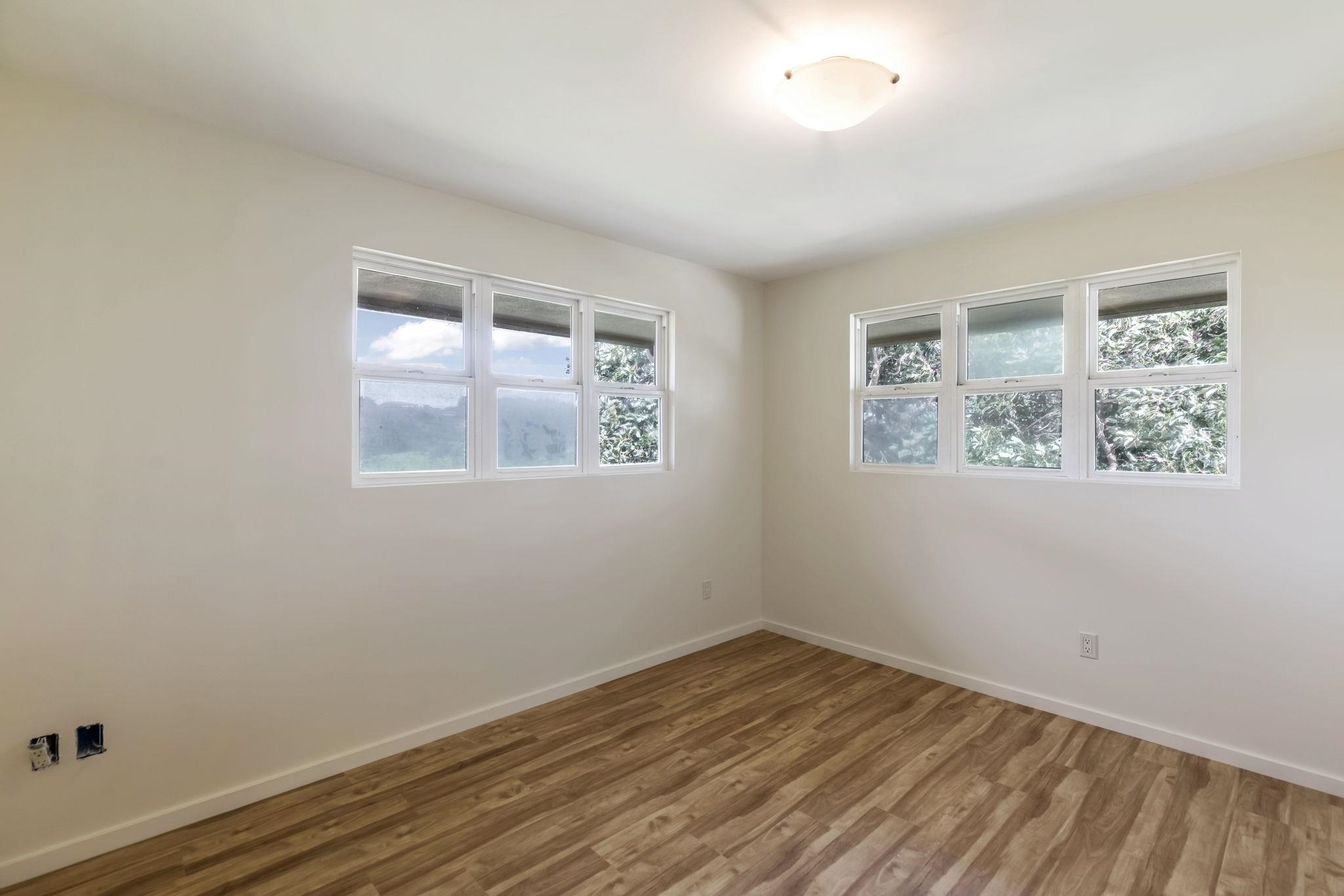 44 Pokoa Place Haiku, HI 96708 - Photo 18 of 29 a view of empty room with wooden floor and fan