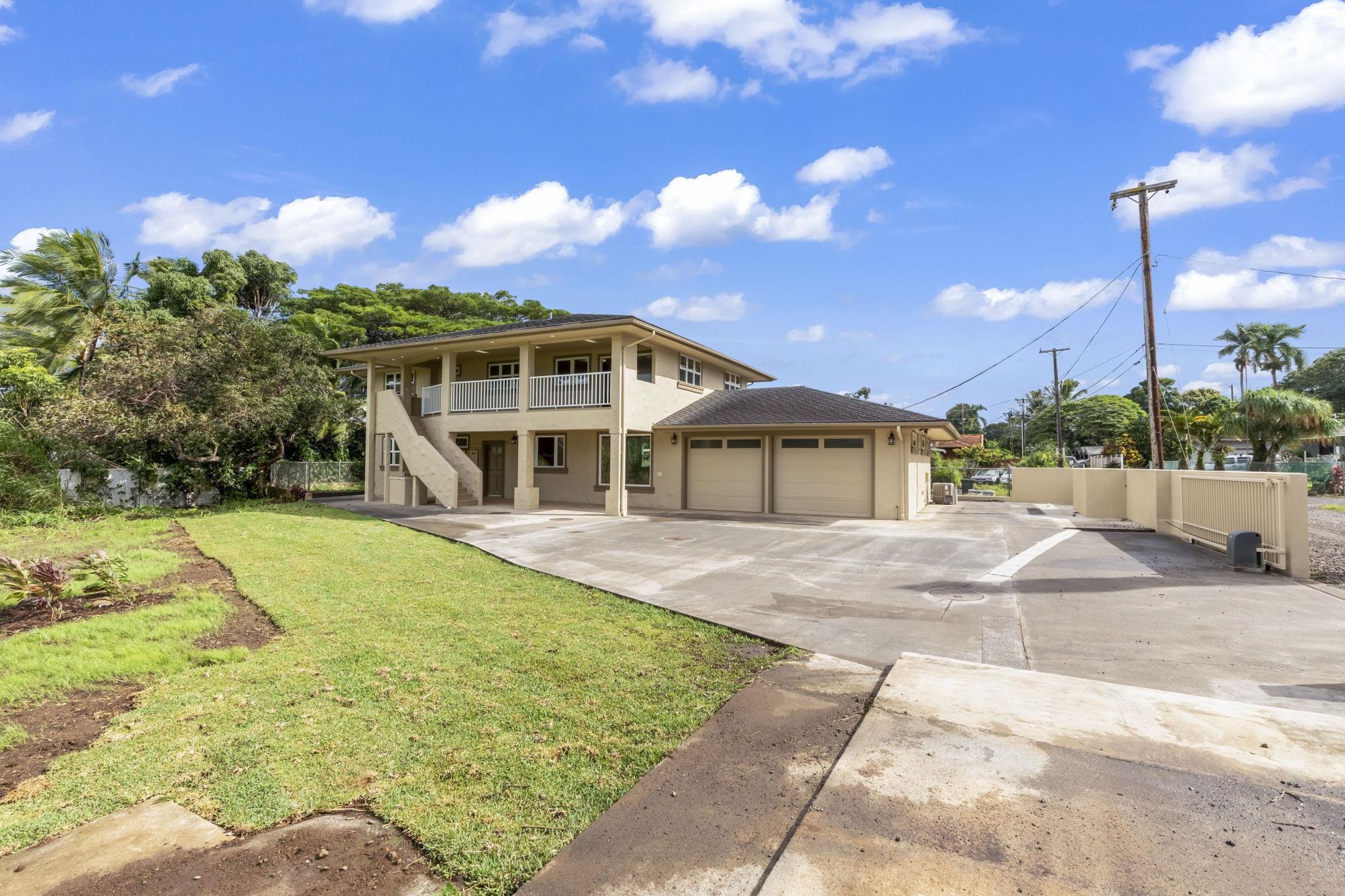 44 Pokoa Place Haiku, HI 96708 - Photo 2 of 29 a front view of a house with a yard and potted plants