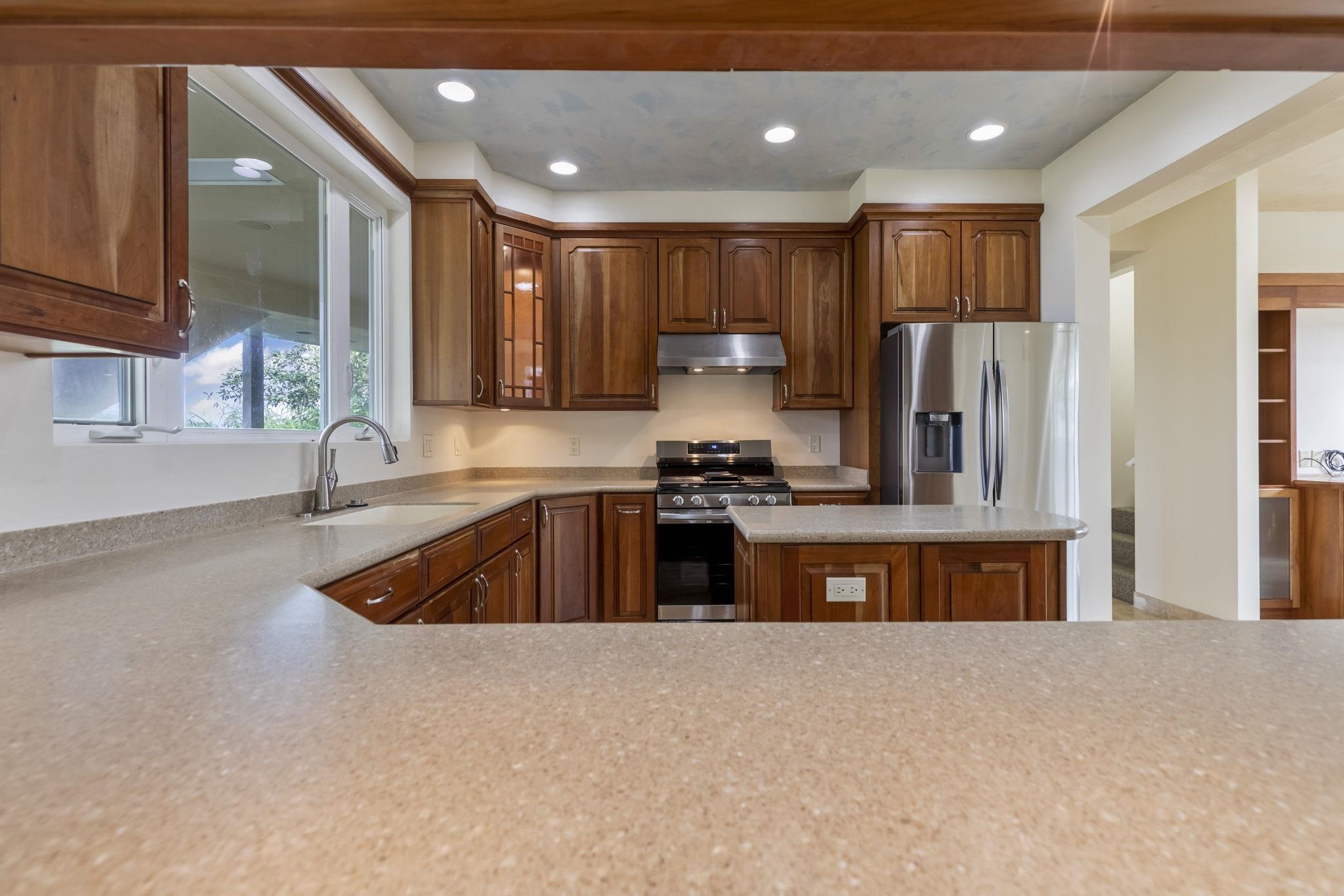 44 Pokoa Place Haiku, HI 96708 - Photo 27 of 29 a kitchen with stainless steel appliances granite countertop a refrigerator a sink dishwasher a stove and a oven with granite countertops