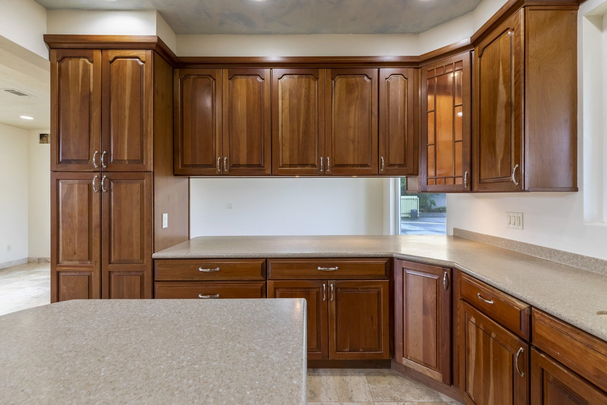 44 Pokoa Place Haiku, HI 96708 - Photo 28 of 29 a kitchen with stainless steel appliances granite countertop wooden cabinets a sink and a window