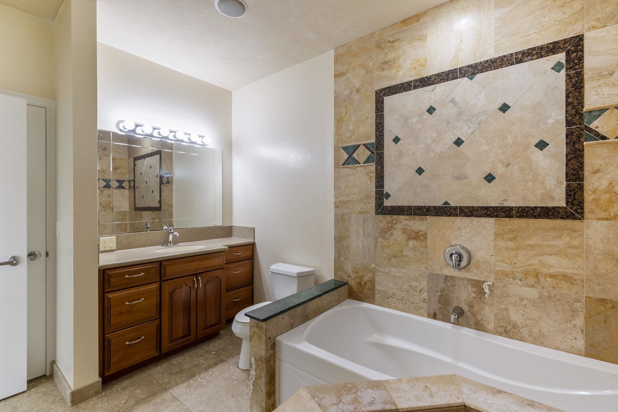 44 Pokoa Place Haiku, HI 96708 - Photo 8 of 29 a bathroom with a granite countertop sink and a mirror