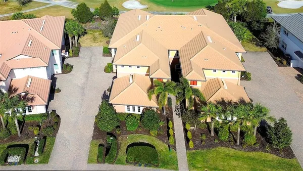 an aerial view of a house with swimming pool and garden