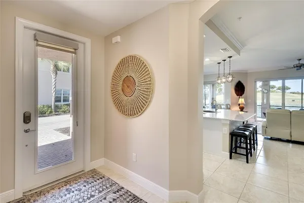 a dining room with furniture a chandelier and window