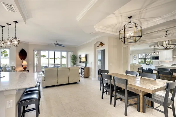a kitchen with kitchen island granite countertop a sink cabinets and stainless steel appliances