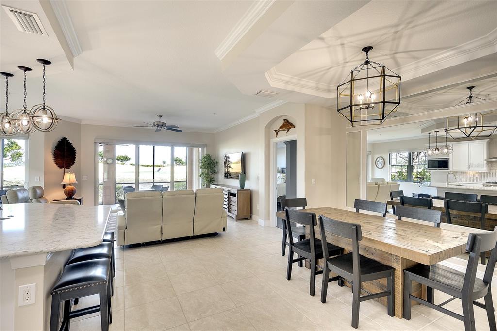 7482 Divot Loop, Unit 6A Bradenton, FL 34202 - Photo 14 of 33 a dining room with furniture a chandelier and window