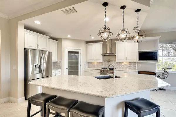 a kitchen with a stove and a white cabinet