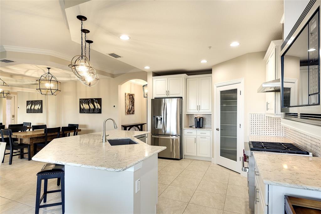 7482 Divot Loop, Unit 6A Bradenton, FL 34202 - Photo 16 of 33 a kitchen with refrigerator and cabinets