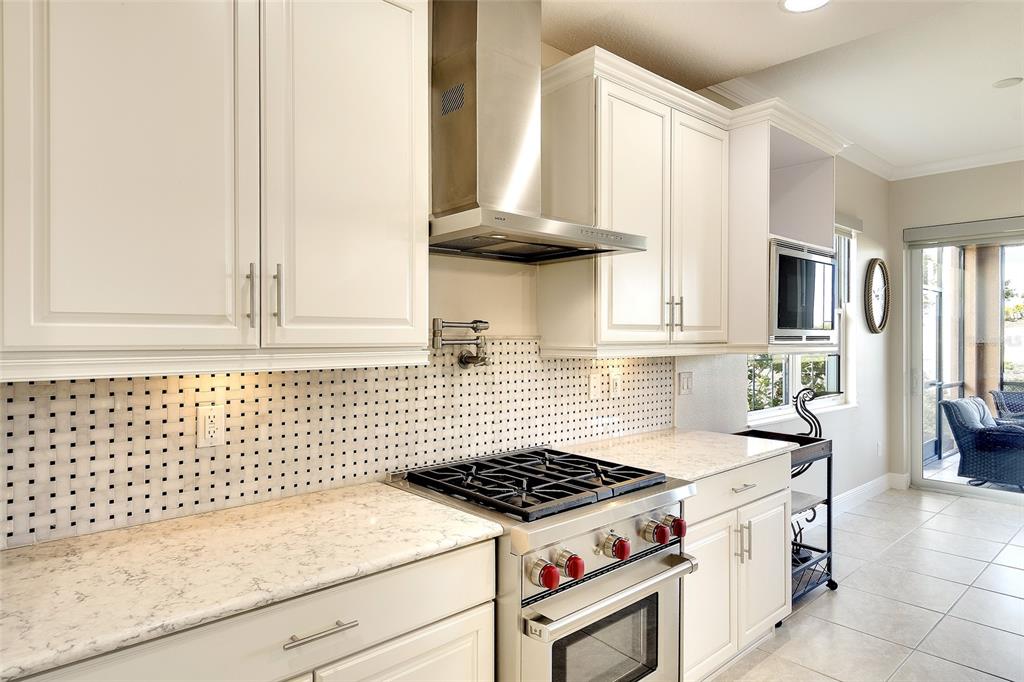7482 Divot Loop, Unit 6A Bradenton, FL 34202 - Photo 18 of 33 a kitchen with a stove and a white cabinet