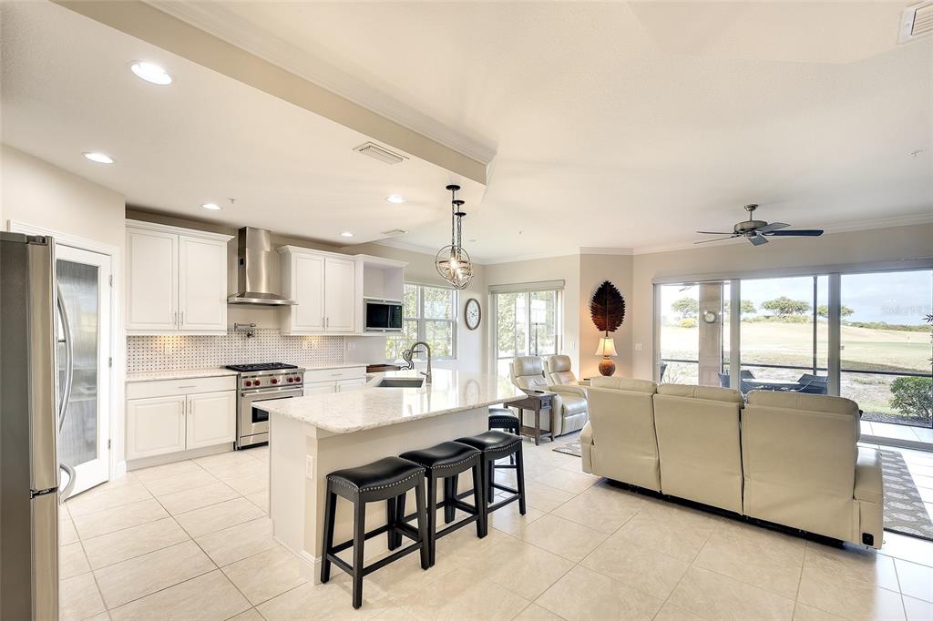 7482 Divot Loop, Unit 6A Bradenton, FL 34202 - Photo 19 of 33 a living room with stainless steel appliances kitchen island granite countertop furniture and a large window