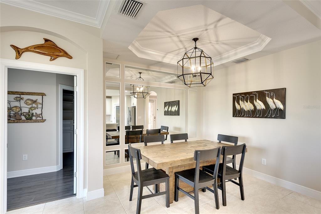 7482 Divot Loop, Unit 6A Bradenton, FL 34202 - Photo 20 of 33 a view of a dining room with furniture and wooden floor