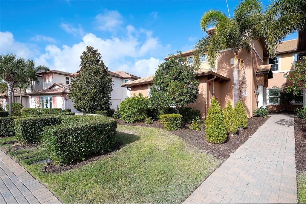 7482 Divot Loop, Unit 6A Bradenton, FL 34202 - Photo 2 of 33 a front view of a house with garden
