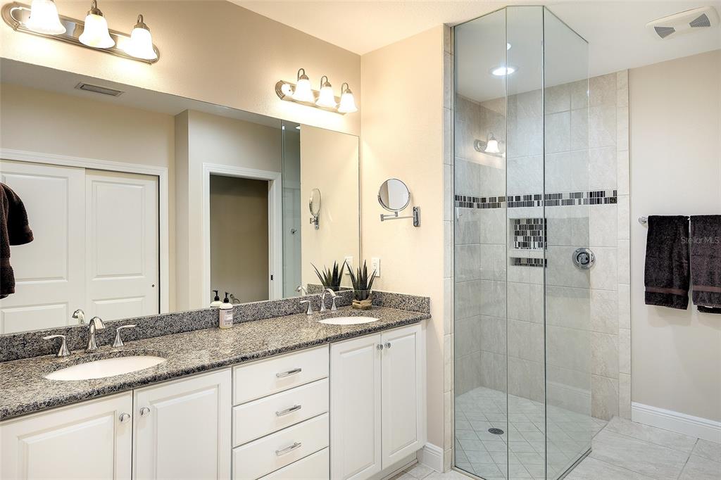 7482 Divot Loop, Unit 6A Bradenton, FL 34202 - Photo 24 of 33 a bathroom with a shower sink and mirror
