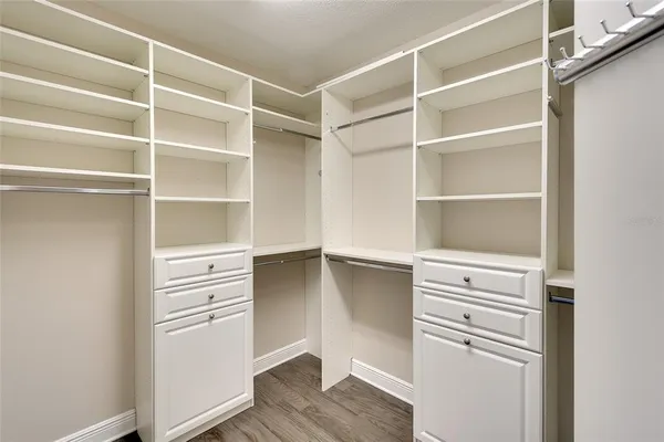 a view of walk in closet with empty racks