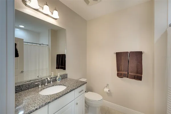 a bathroom with a closet and mirror
