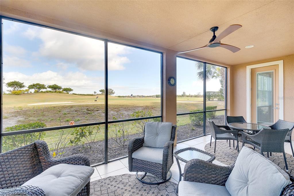 7482 Divot Loop, Unit 6A Bradenton, FL 34202 - Photo 6 of 33 a living room with furniture and floor to ceiling windows