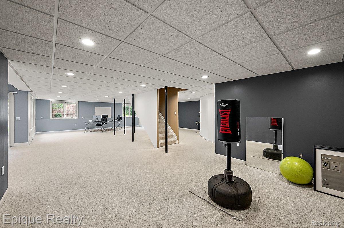 1909 Catlin Drive Rochester, MI 48306 - Photo 50 of 76 Spacious lower level featuring light-colored carpeting, recessed lighting, and a neutral drop ceiling